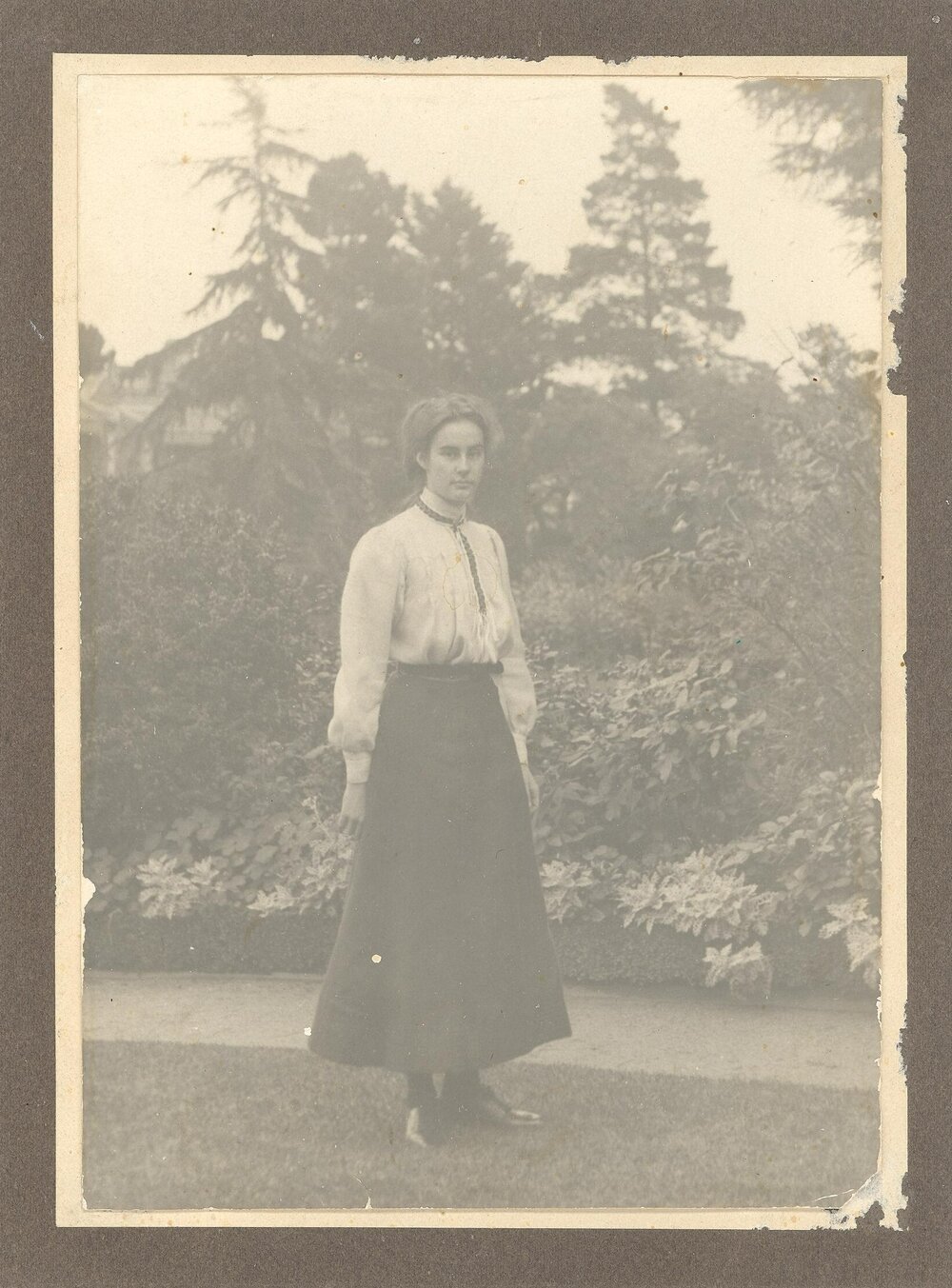Photograph of Eloise Trengrove, attended MLC 1909, perhaps in front gardens