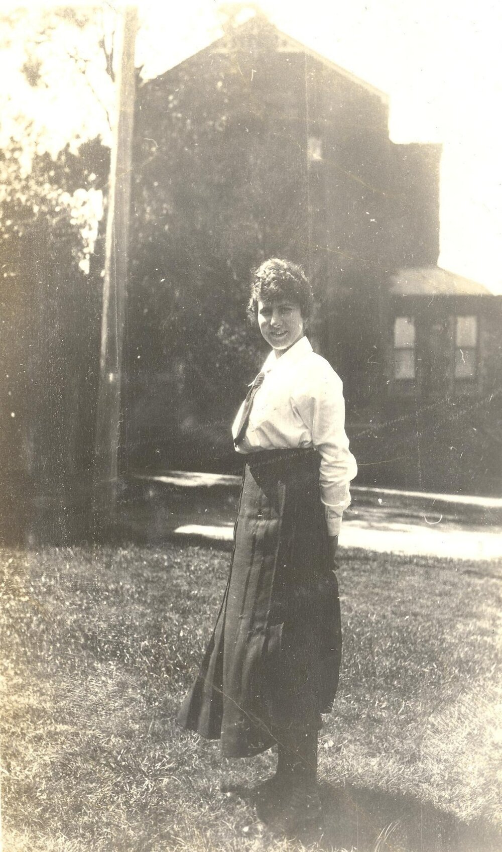 Photo of Winnie Woodmason on lawn, pobably MLC grounds, c.1917