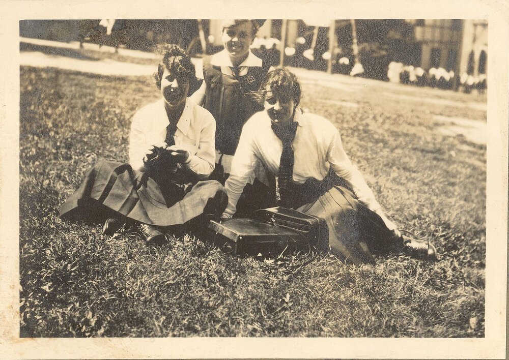 Photo of three students seated on front lawn, c.1916-17 (Woodmason donation)