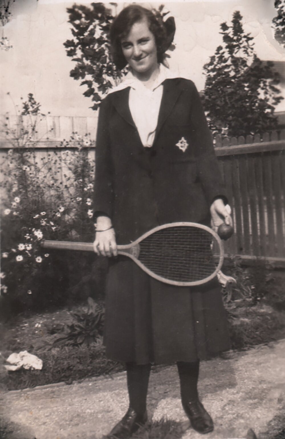 Photograph of Dorothy Watt in uniform holding tennis racket, 1919