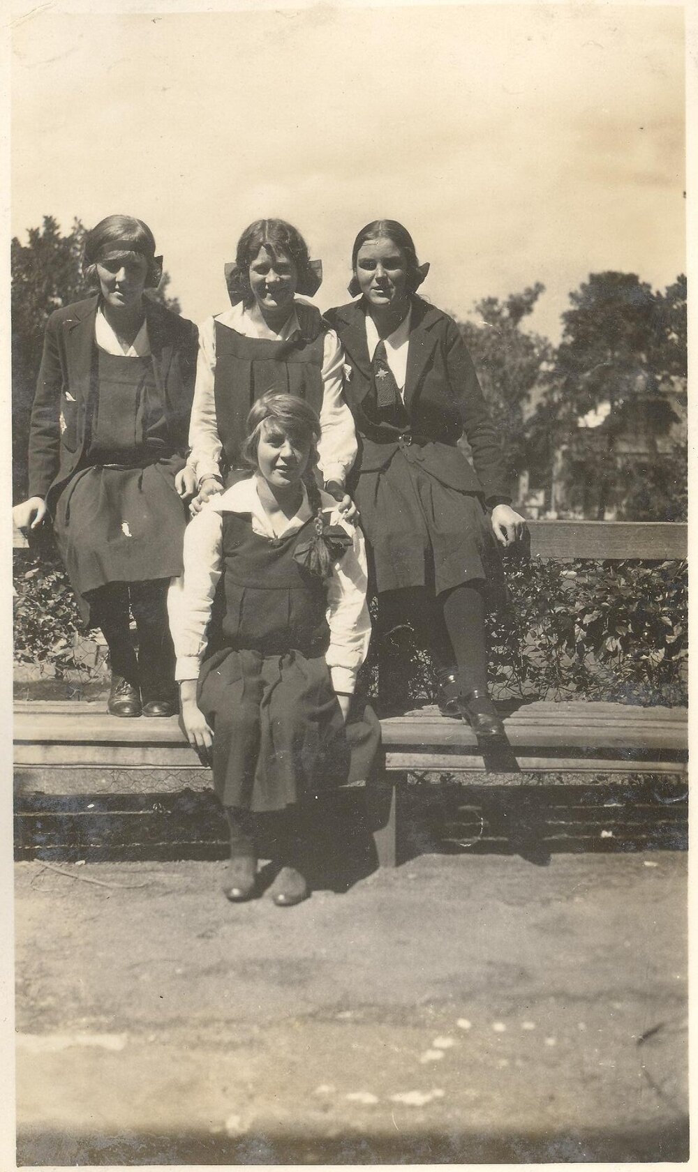 Photo of four students on bench - probably front gardens - c.1923