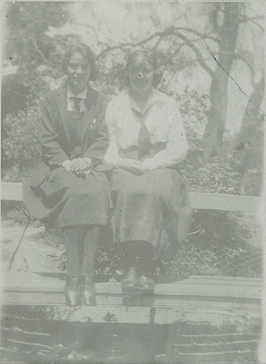 Photo (faded) of two students on bench - probably front gardens - c.1923