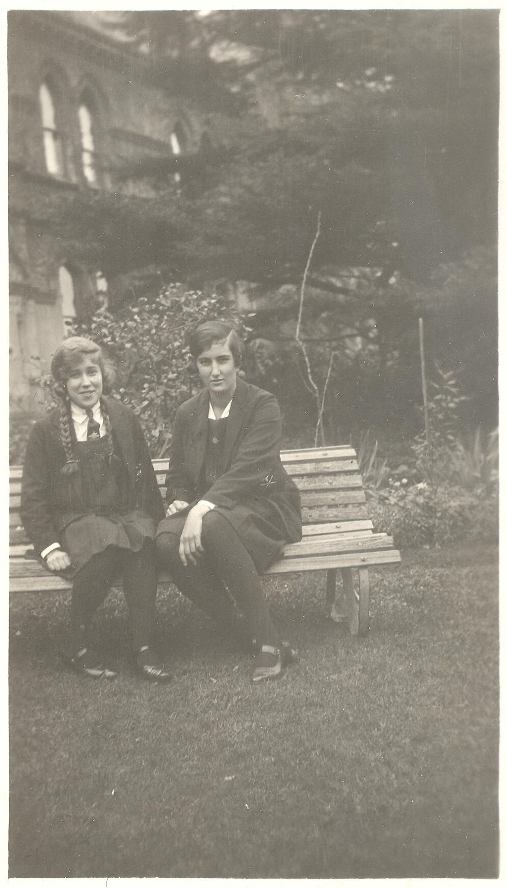Photograph of student Essie Cox and friend (wearing baseball colours blazer) front garden c.1928