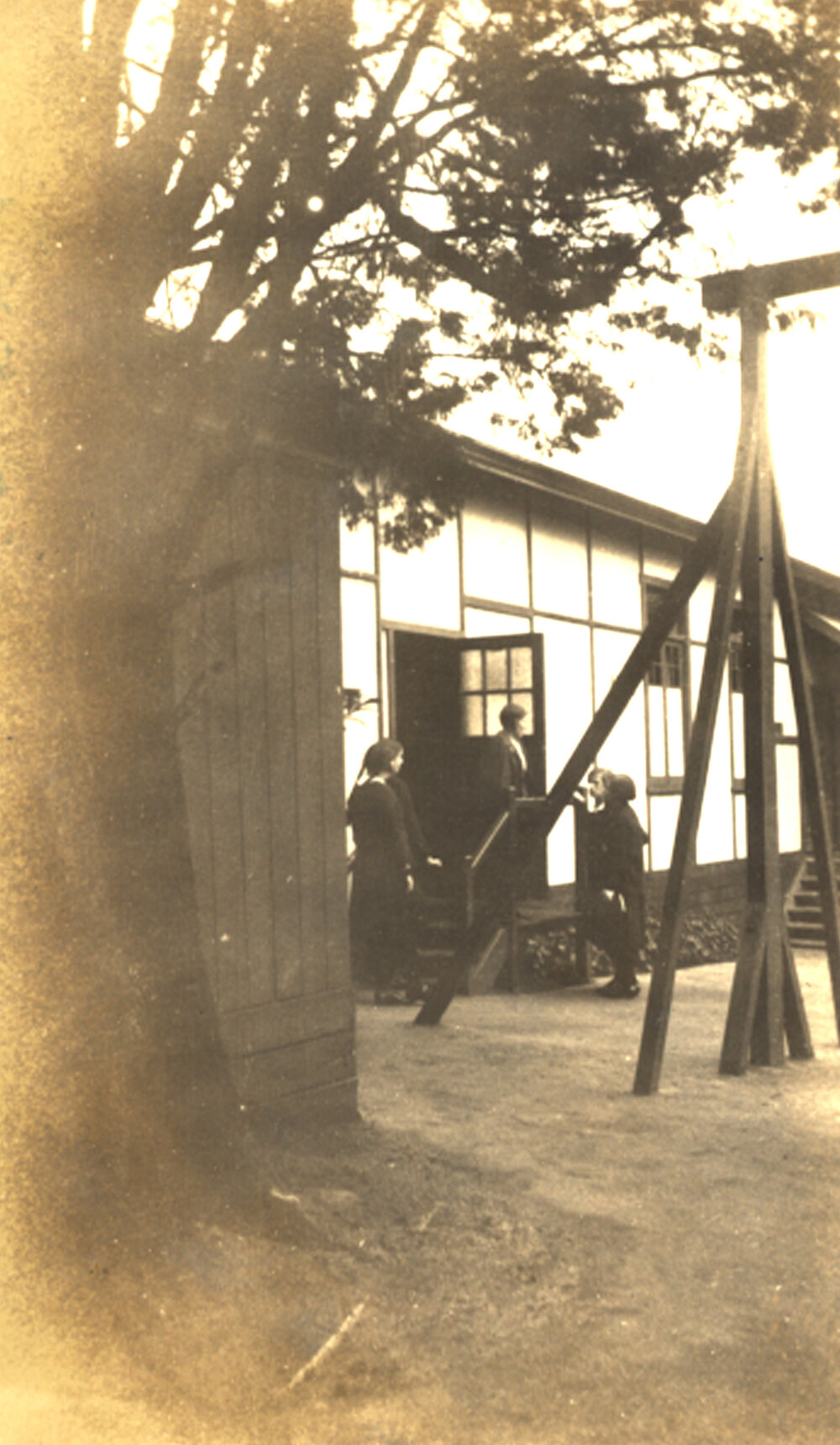 Photo of teacher Miss Betts at Teachers' Common Room Door on quad, c.1932