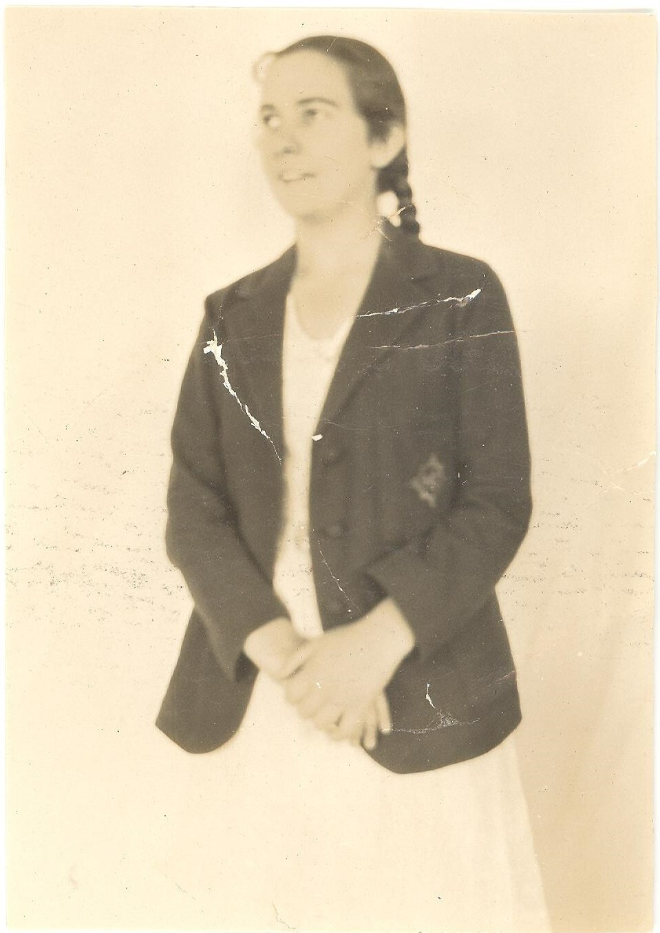 Photograph of Betty Coulson (Allen 1931) in blazer and white Speech Night dress.