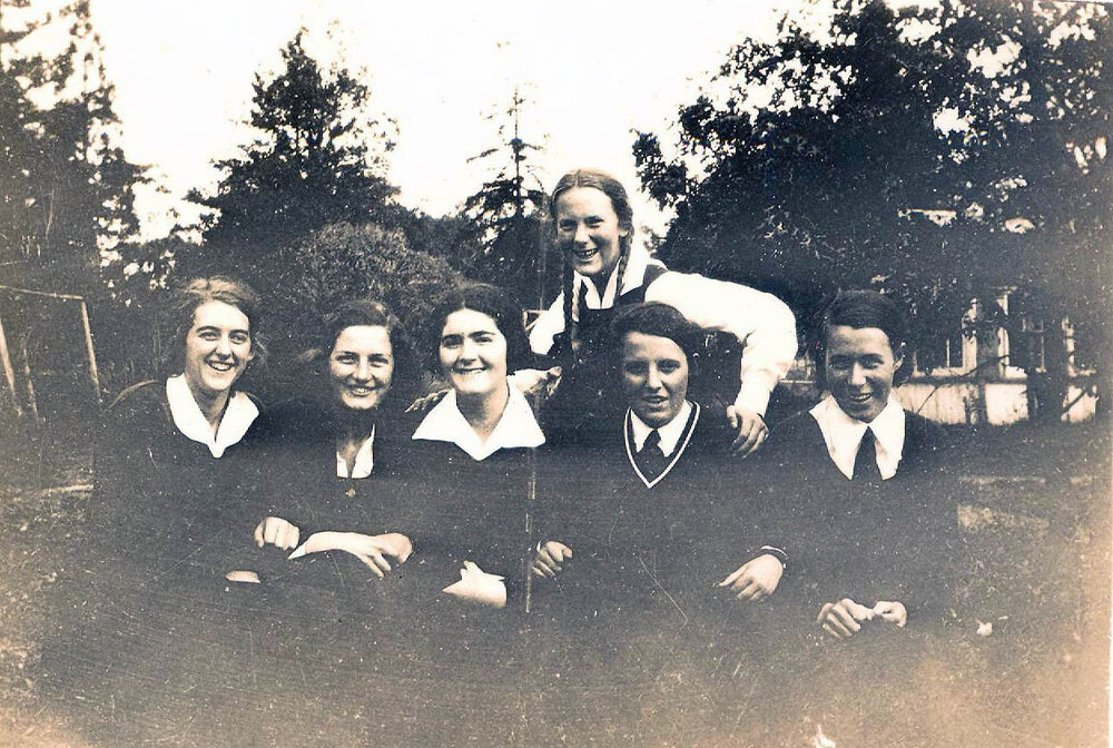 Small-format photo of six students, likely front gardens, 1933