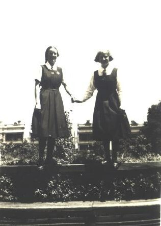 Roma and Jean on fence, Fitchett Hall, 1934