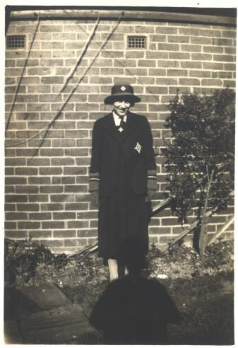 Joan Bairstow in school uniform at home, 1935