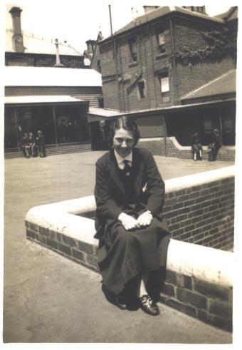 Joan Bairstow on wall in Quad, 1935