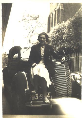 Joan Bairstow sitting on Car, c.1935