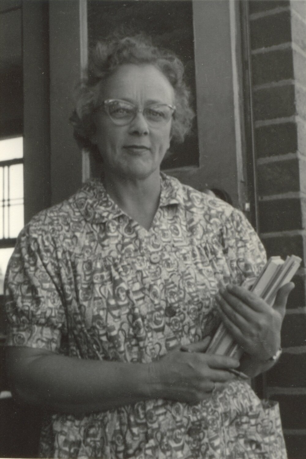 Photo of Elsa Tyler holding books, 1940s