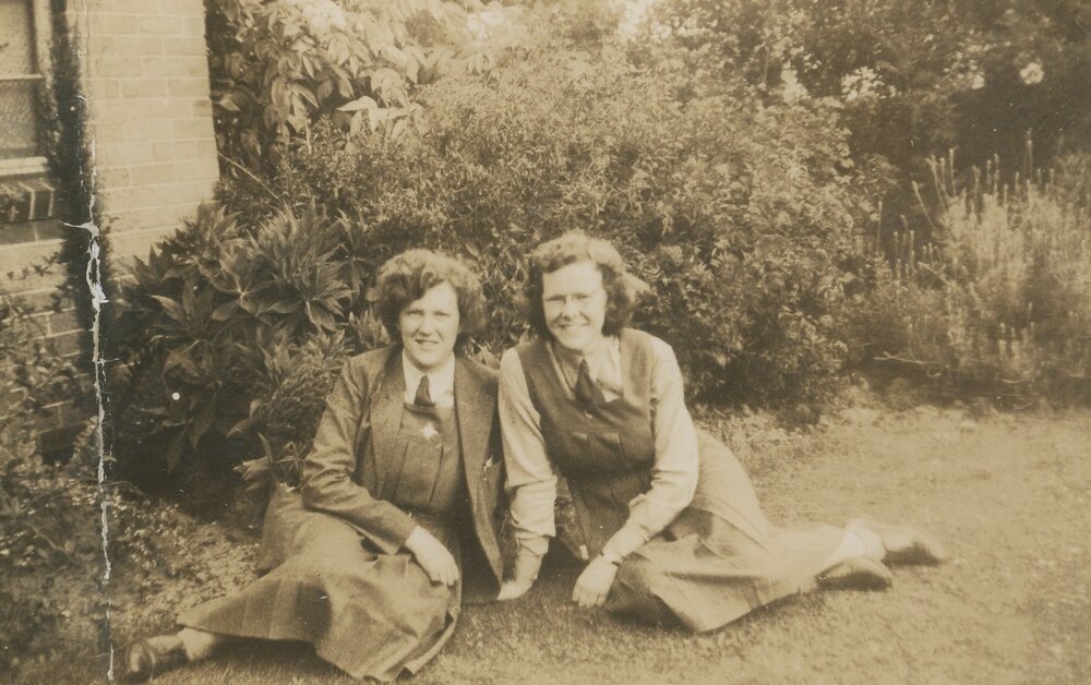 Photo of Margaret Rentoul &amp; Barbara Binder sitting on grass, 1943