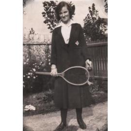 Photograph of Dorothy Watt in uniform holding tennis racket, 1919