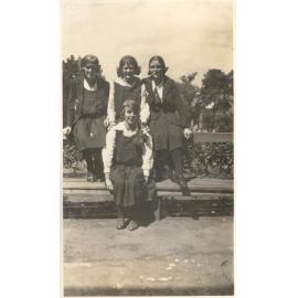 Photo of four students on bench - probably front gardens - c.1923