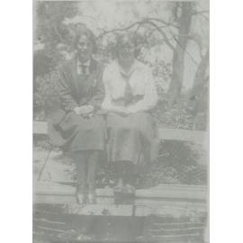Photo (faded) of two students on bench - probably front gardens - c.1923