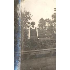 Photo of student on bench - probably front gardens - cc.1923