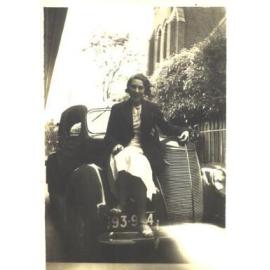 Joan Bairstow sitting on Car, c.1935