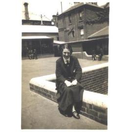 Joan Bairstow on wall in Quad, 1935