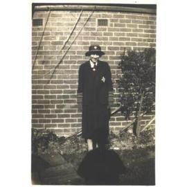 Joan Bairstow in school uniform at home, 1935