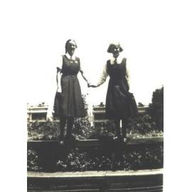 Roma and Jean on fence, Fitchett Hall, 1934
