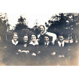 Small-format photo of six students, likely front gardens, 1933