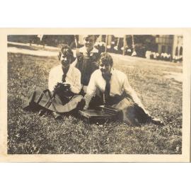 Photo of three students seated on front lawn, c.1916-17 (Woodmason donation)