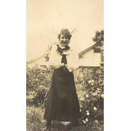 Photo of Winnie Woodmason in uniform but with bottle and glass, clown collar, c.1917
