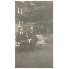 Photograph of student Essie Cox and friend (wearing baseball colours blazer) front garden c.1928