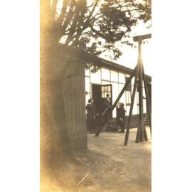 Photo of teacher Miss Betts at Teachers' Common Room Door on quad, c.1932