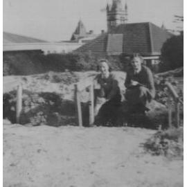 Photo of two students in air raid trenches at MLC, 1940s