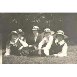 Photo of five students wearing MLC straw hats, lounging on lawn, labelled "Sports Day 1920"